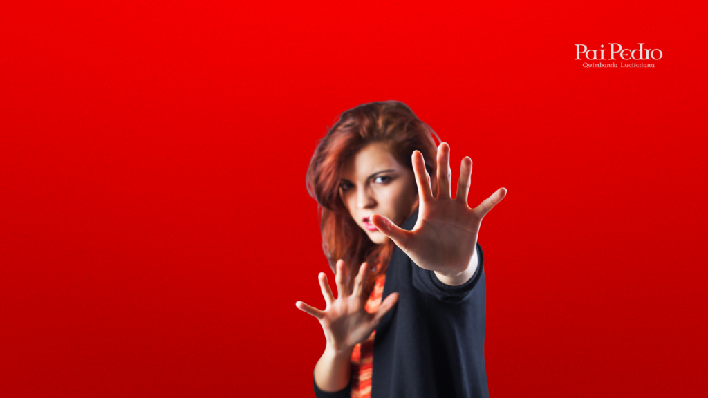 Mulher determinada com as mãos levantadas em sinal de bloqueio e defesa, demonstrando atitude de proteção e autoconfiança diante de ameaças.