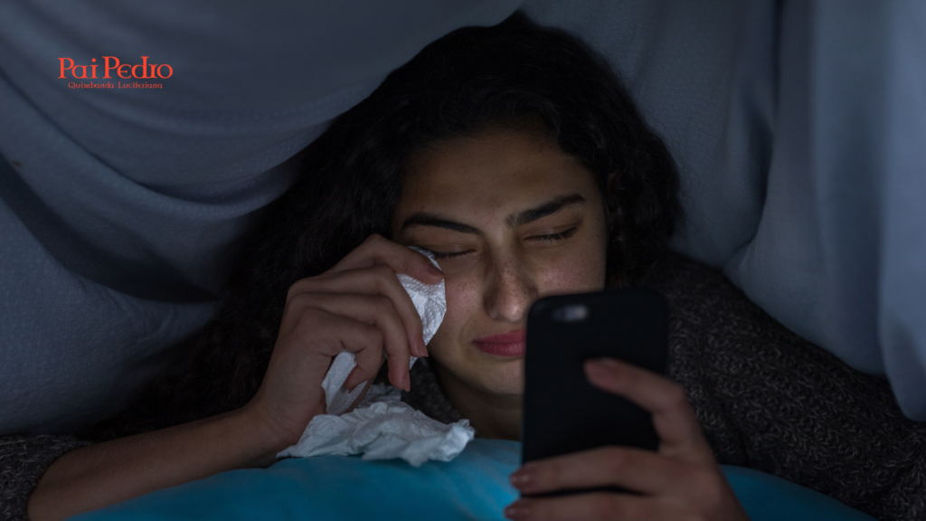Mulher chorando sozinha enquanto segura o celular, representando a dor e as decepções causadas por um webnamoro ilusório.